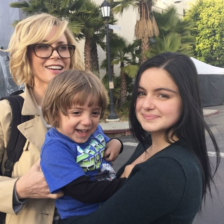 two women and a young boy posing for the camera