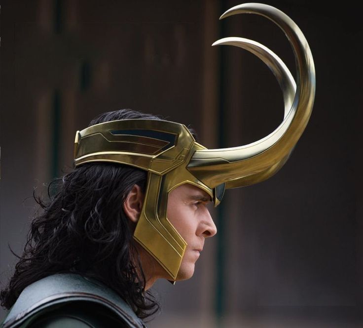 a close up of a person wearing a helmet with horns