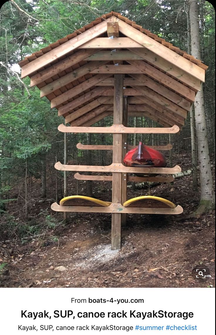 a wooden structure with kayaks on it in the woods