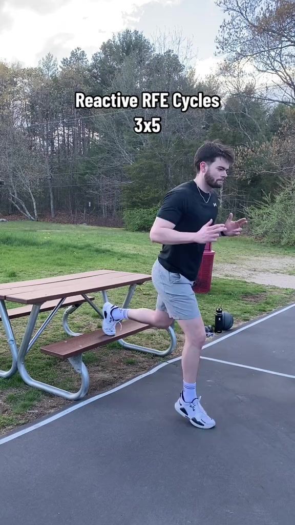 a man is running in front of a picnic table