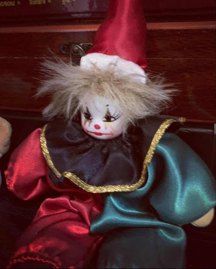 a creepy clown doll sitting on top of a table