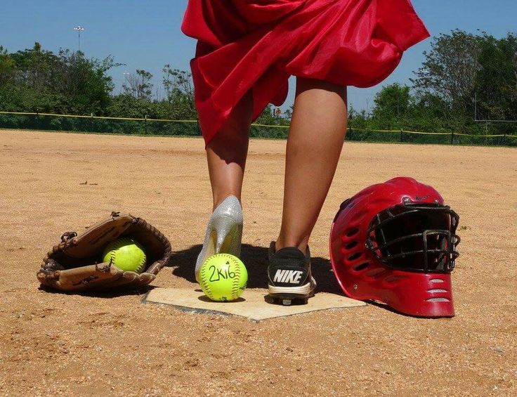 a catchers mitt, helmet and ball on the ground