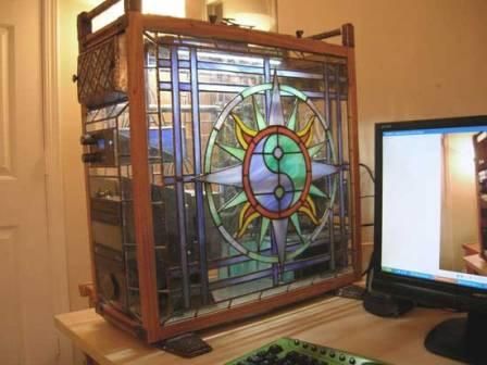 a stained glass window sitting on top of a desk next to a computer monitor and keyboard