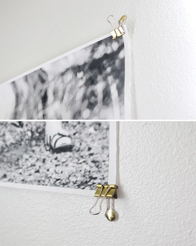 two pictures hanging on the wall with hooks