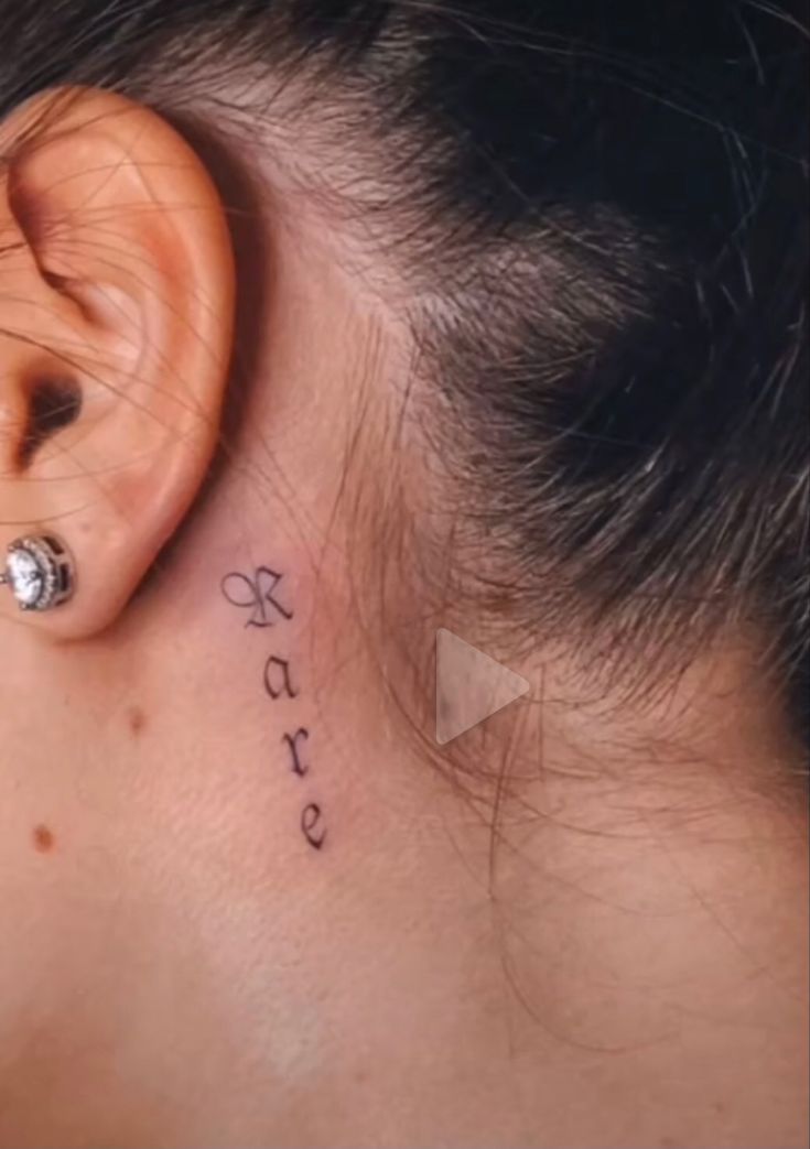 a woman's ear with the word love written on her left side behind the ear