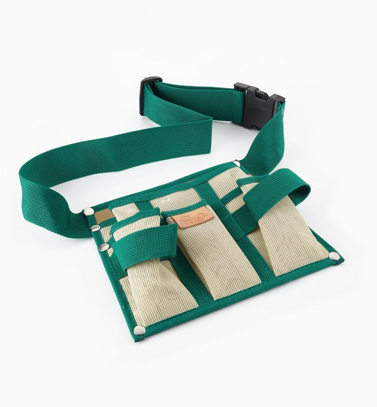 a green belt with three pieces of fabric in it and one piece is open to show the contents