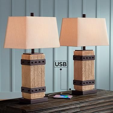 two lamps are sitting on a table with a wooden box underneath them and one light is turned off