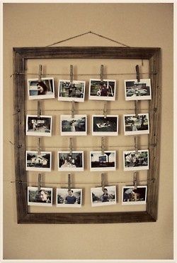 an old wooden frame with photos hanging on it