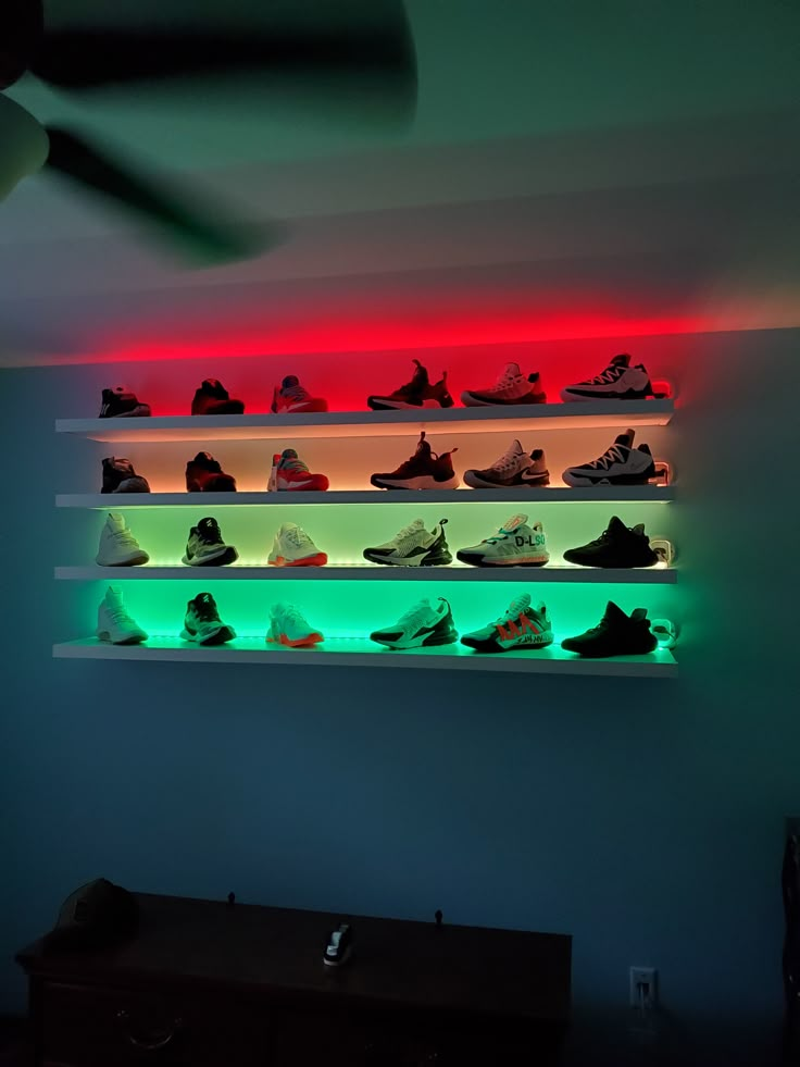 a wall mounted shelf filled with lots of different types of shoes on top of it