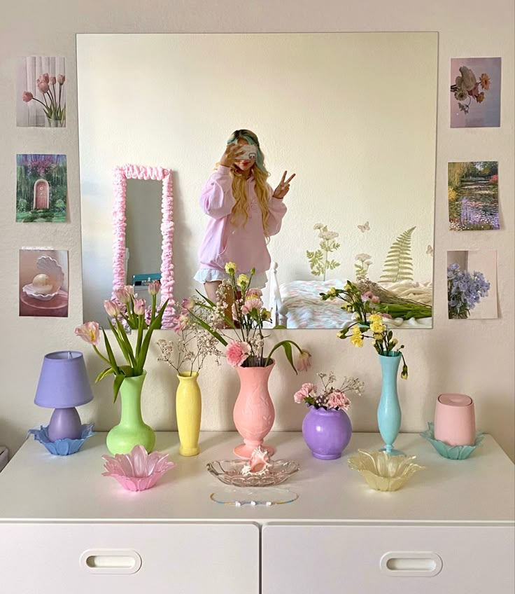 a girl standing in front of a mirror surrounded by vases and flowers