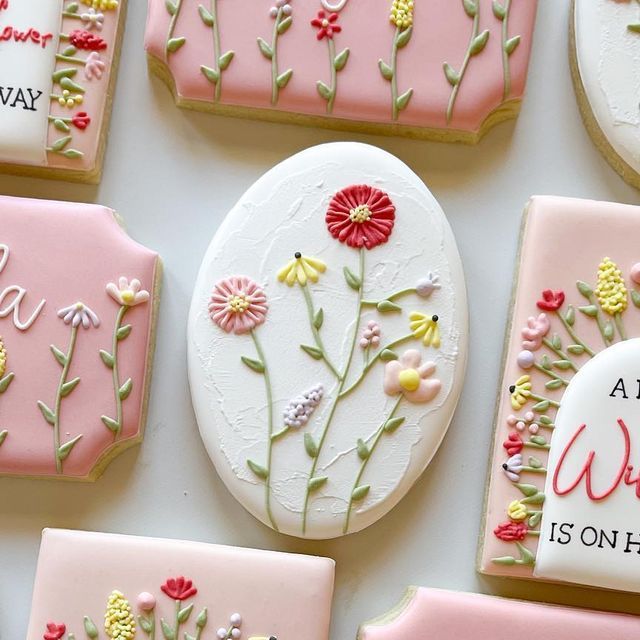 decorated cookies with flowers and words on them