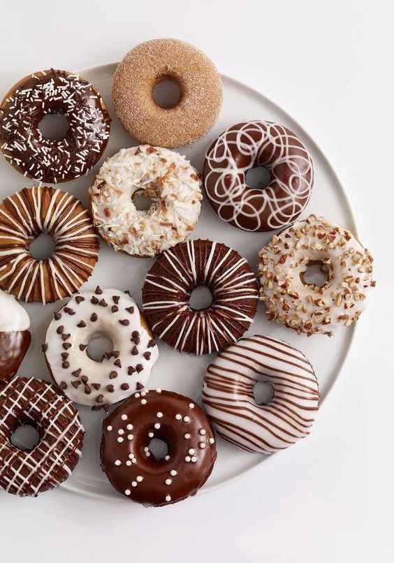 a white plate topped with lots of donuts