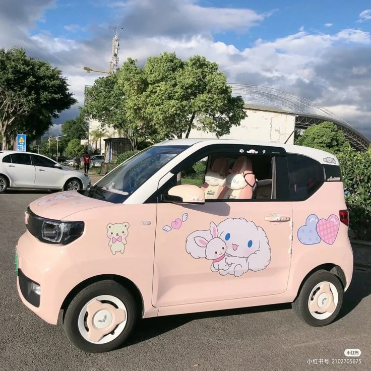 a small pink car with cartoon animals painted on the side