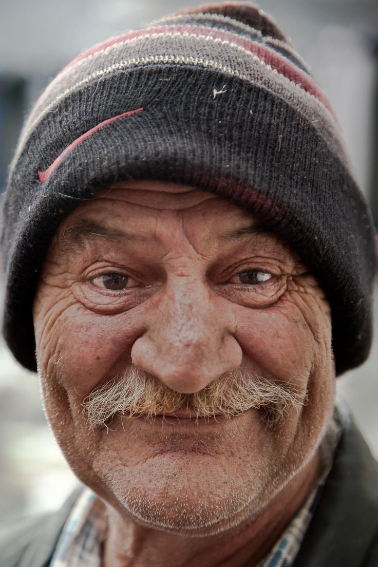 an old man with a mustache and a beanie