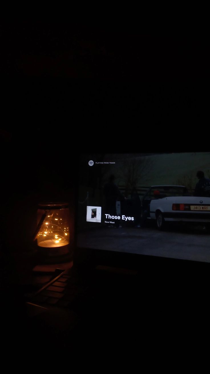 a television screen with the image of a car on it's display in the dark