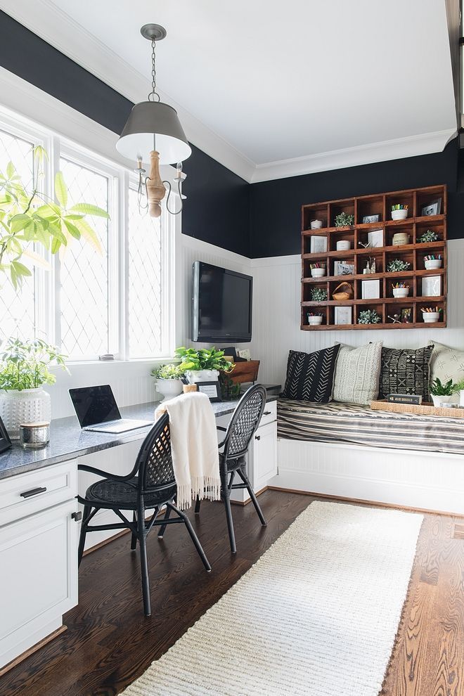 a living room filled with furniture and a white rug on top of a hard wood floor