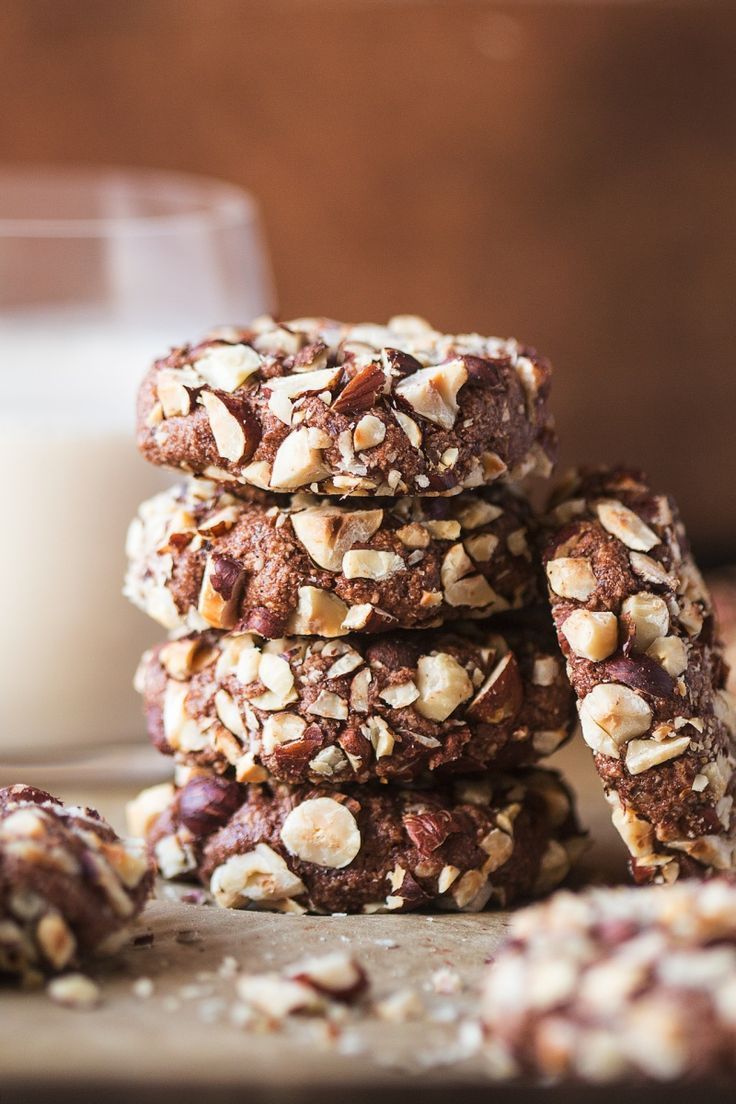 several cookies stacked on top of each other next to a glass of milk