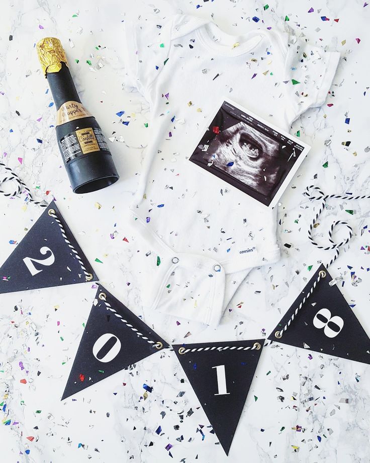 a bottle of champagne and some confetti on a table