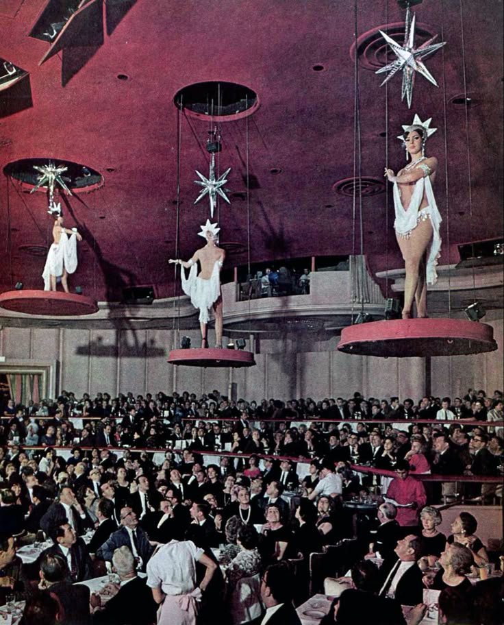 an old fashion show with people dressed in costumes and standing on star - shaped platforms