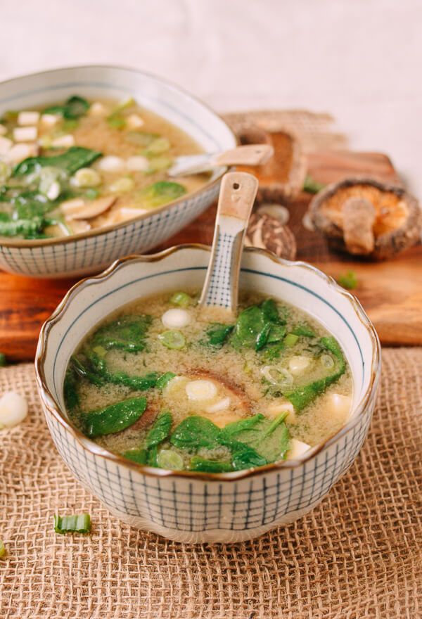 two bowls filled with soup sitting on top of a table