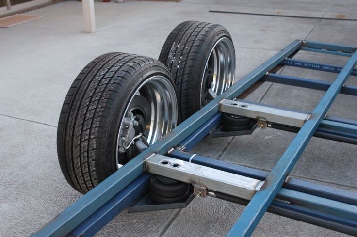 two wheels are attached to the side of a trailer