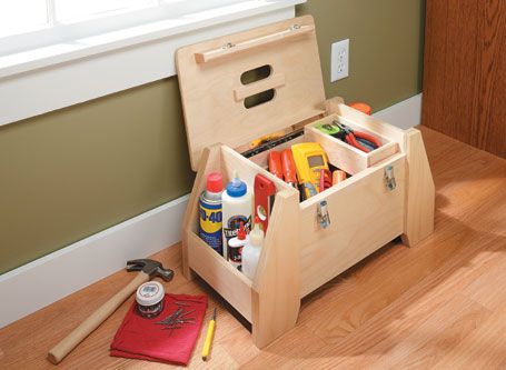 a wooden tool box filled with tools on top of a hard wood floor