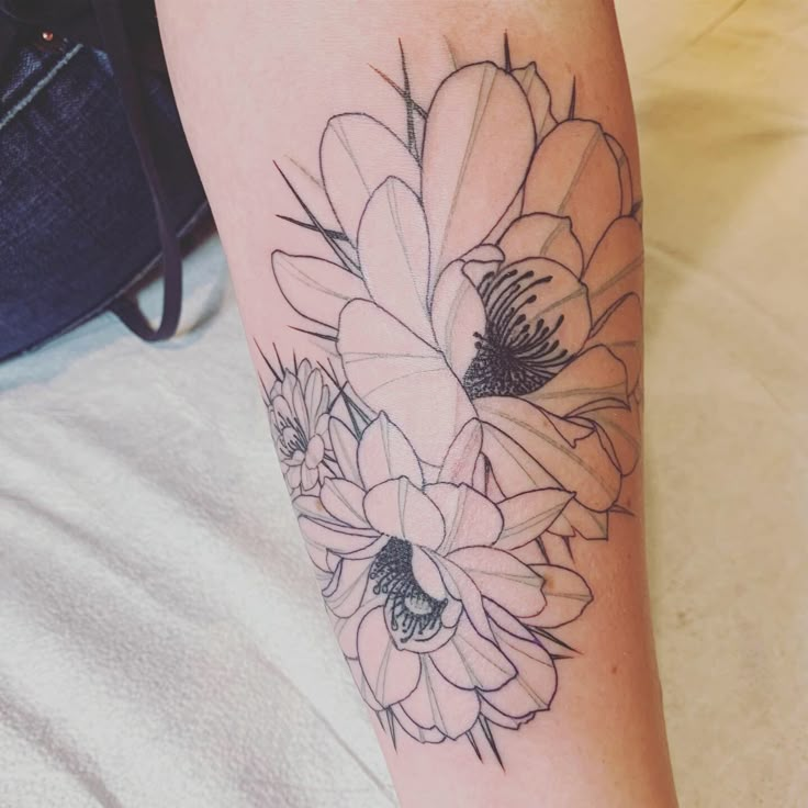 a woman's arm with flowers on it