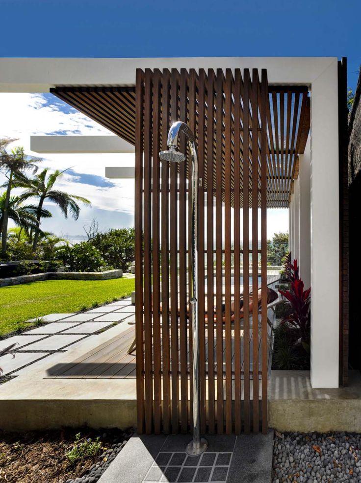 the entrance to a modern home with wood slats