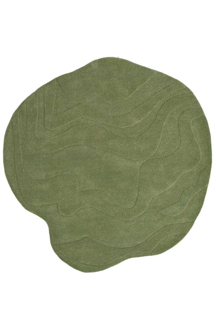 a green rug with wavy lines in the middle on a white background, it looks like an oval shape