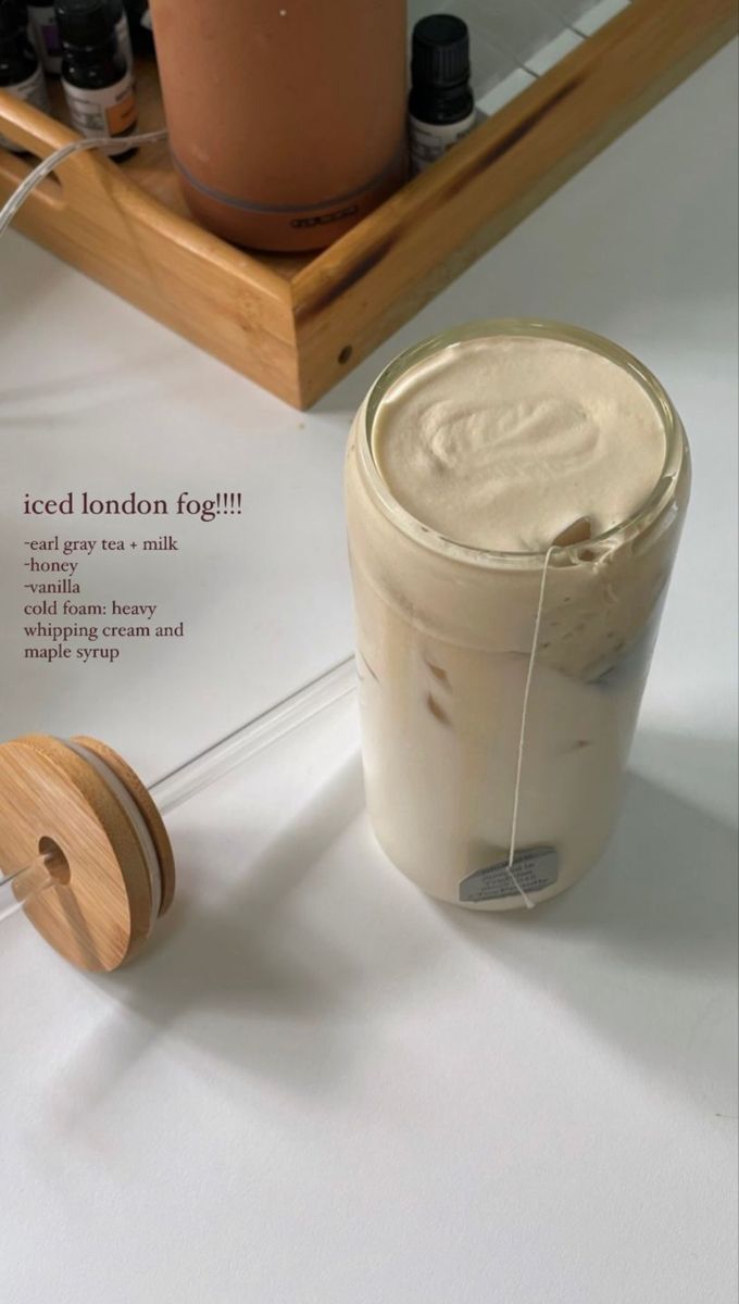 the contents of an iced london fog tea in a glass jar and wooden spool