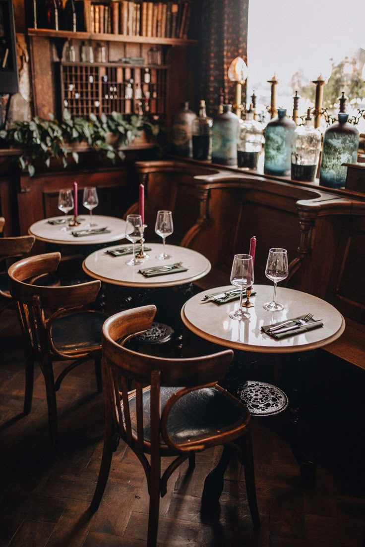 the tables are set with wine glasses on them