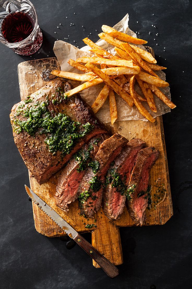 steak and french fries on a cutting board