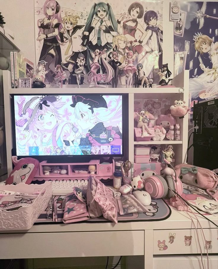 a desktop computer sitting on top of a desk covered in anime character wallpapers