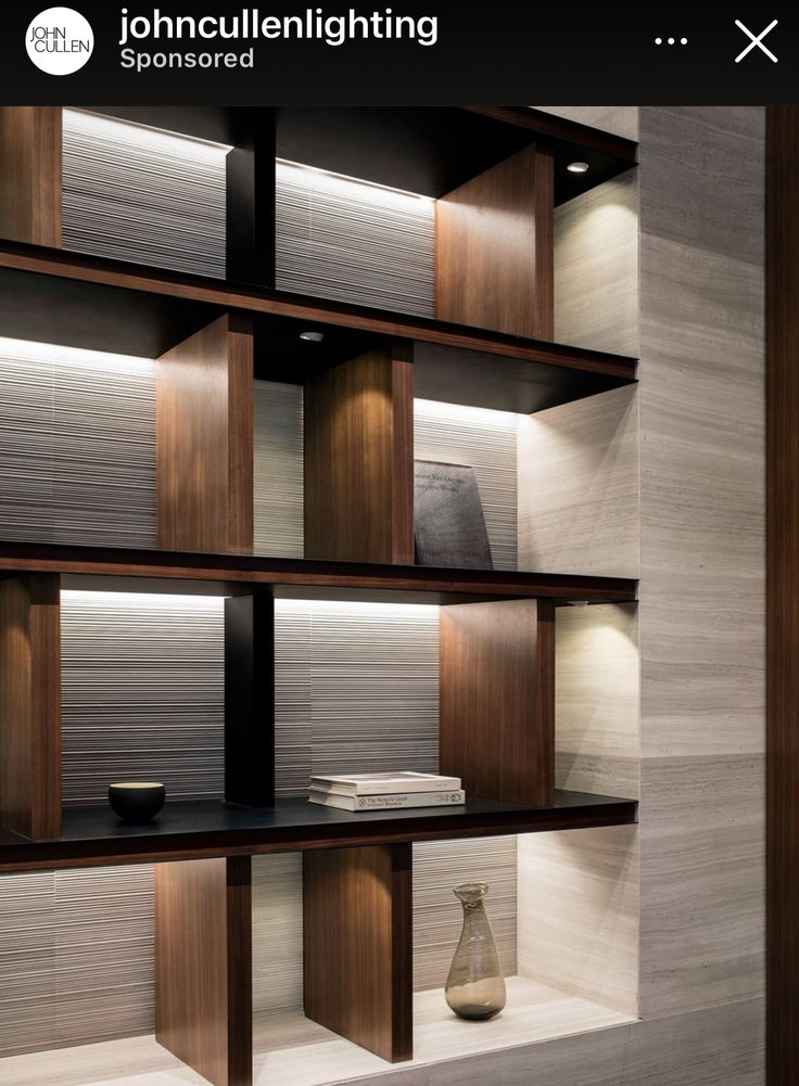 an empty shelf in a room with some vases and bookshelves on it