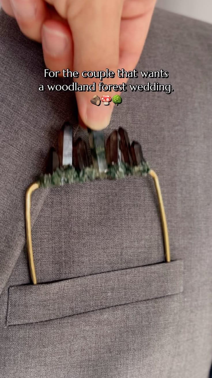 a man in a gray suit is holding his tie clip with the words, for the couple that wants a woodland forest wedding