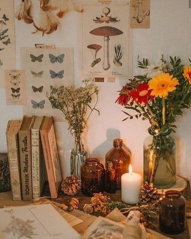 a table topped with books and vases filled with flowers