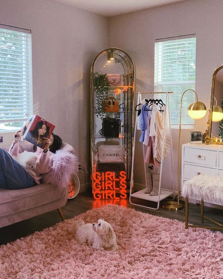 a dog laying on a pink rug in a bedroom