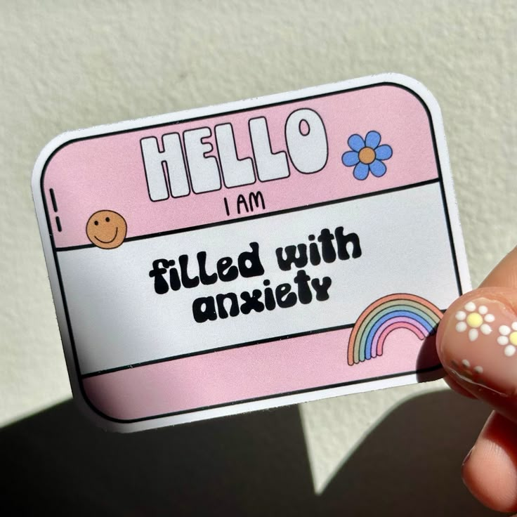 a person holding up a hello kitty sticker in their hand with the words, i am filled with aniety