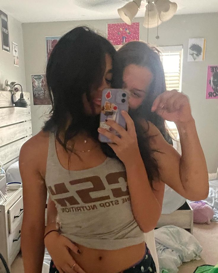 two women taking a selfie in the mirror