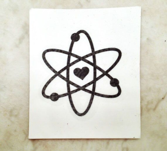 a black and white image of an atomic symbol on a square paper with a heart in the center