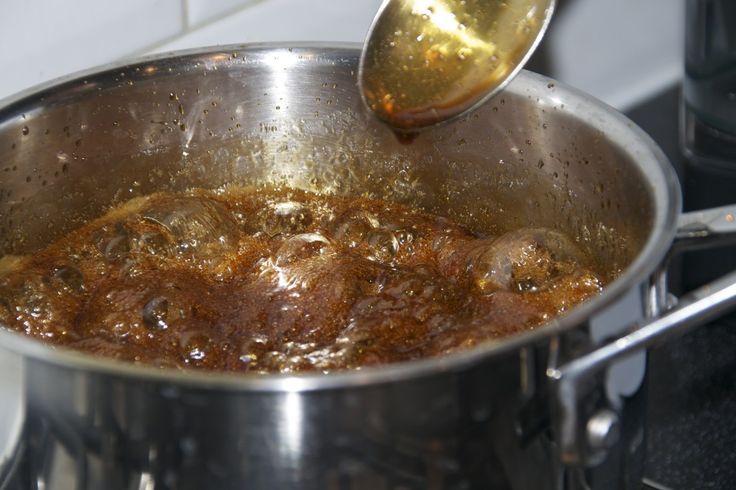 a pot filled with food cooking on top of a stove