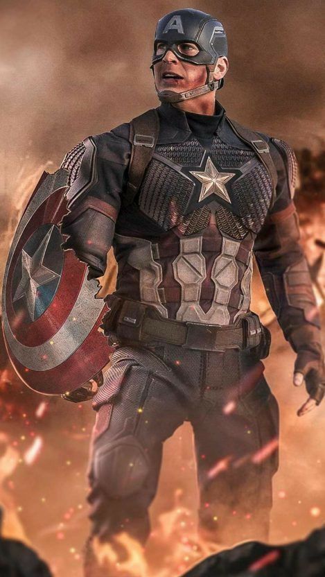 captain america is standing in front of a fire with his shield on it's chest