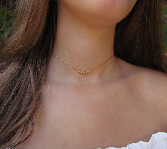 Delicate choker necklace with dainty beads in 14k gold fill or sterling silver. These beads are inspired by the Black Pepper seeds! Personalize your necklace with the number of beads you would like (choose in the drop-down menu). This gold beaded necklace is a great everyday stacking necklace or wear it on it's own for a minimalist look. #necklace #layerednecklace #RavitSchwartz Simple Gold Choker Necklace, Delicate Choker Necklace, Stacking Necklace, Delicate Choker, Gold Beaded Necklace, Starburst Necklace, Layered Choker Necklace, Layered Chokers, Stacked Necklaces