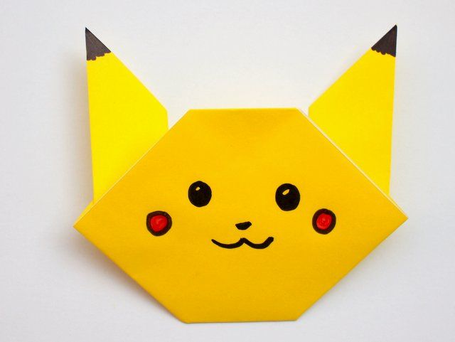 a yellow origami pokemon pikachu with red eyes and black horns on it's head