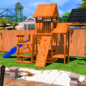 a children's wooden playground set in the backyard