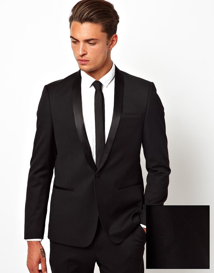 a man in a black suit and tie