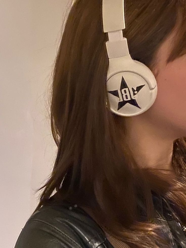 a woman wearing headphones with the word hb on it's earbands