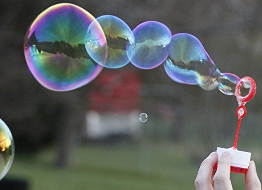 someone is blowing soap bubbles in the air