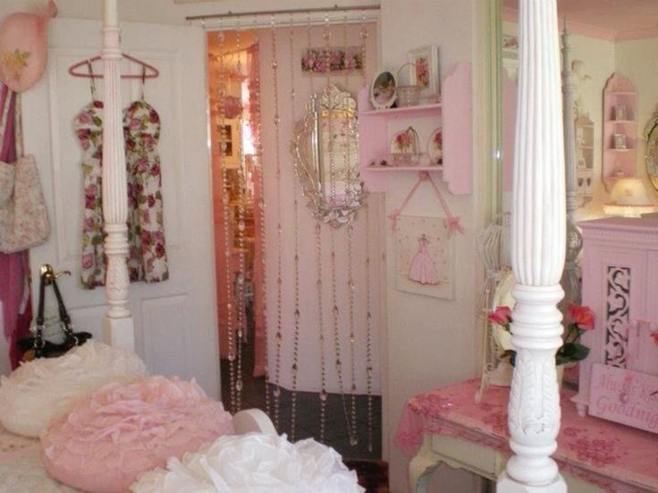 a bedroom with pink and white decor on the walls