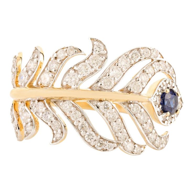 This exquisite miracle ring draws inspiration from the enchanting tales of Lord Krishna, featuring a striking feather design reminiscent of his iconic peacock feather. Adorned with vibrant blue sapphires and shimmering diamonds, this piece captures the essence of divine beauty. Crafted with precision, the adjustable band ensures a perfect fit, symbolizing the adaptability and grace of Krishna himself. The harmonious blend of gemstones reflects a captivating balance of elegance and style, making it a stunning accessory for any occasion, whether celebrating love, devotion, or joyous gatherings.  PRODUCT DETAILS :-  Material - 18K Solid Yellow Gold Gemstone - Blue Sapphire Gemstone Weight - 0.2 cts Gemstone pcs - 1 Gemstone shape - Round Gemstone size - 3.2 mm Diamond Weight - 1.07 cts  Diamo Ruby Solitaire Ring, Aquamarine Solitaire Ring, Gemstone Solitaire Ring, Sapphire Solitaire Ring, White Gold Solitaire, Gold Solitaire Ring, Sapphire Solitaire, Contemporary Ring, Sapphire Color